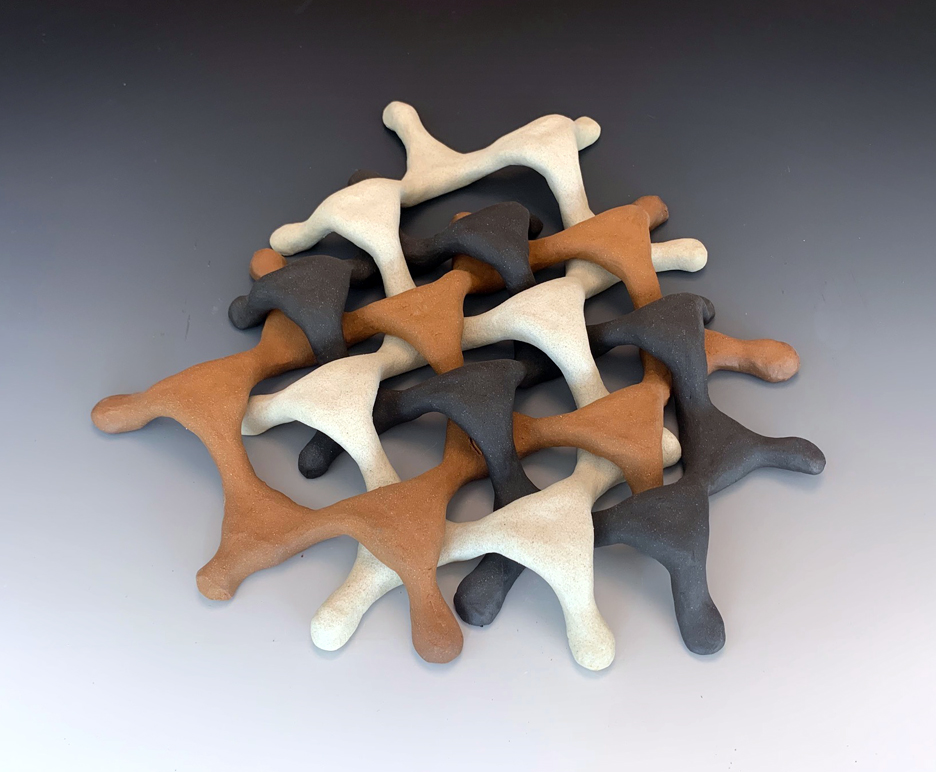 Ceramic sculpture with interlocking parts.