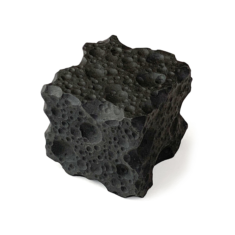 Ceramic sculpture of a cube wth craters.