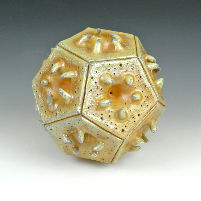 Ceramic sculpture of a biological polyhedral form.