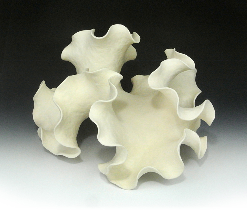 Negative-curvature abstract ceramic sculpture with an asymmetric form.