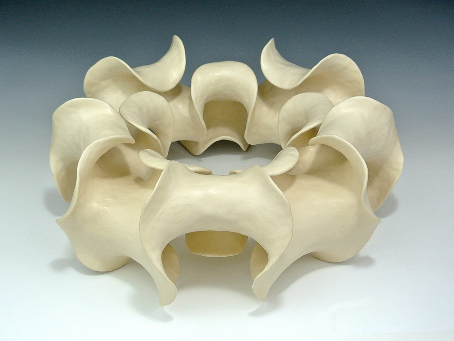 Ring-shaped ceramic sculpture with negative curvature.