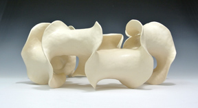 Ring-shaped ceramic sculpture with negative curvature.