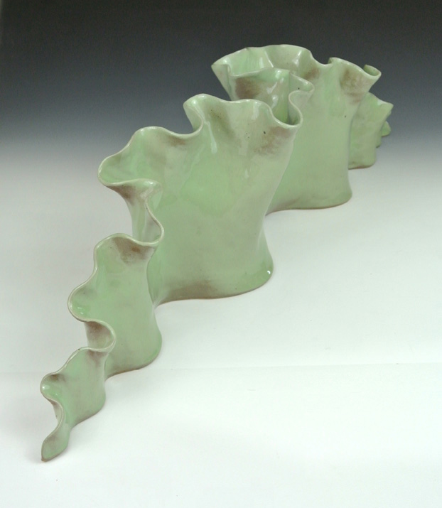Ceramic sculpture of a meandering negative curature form.