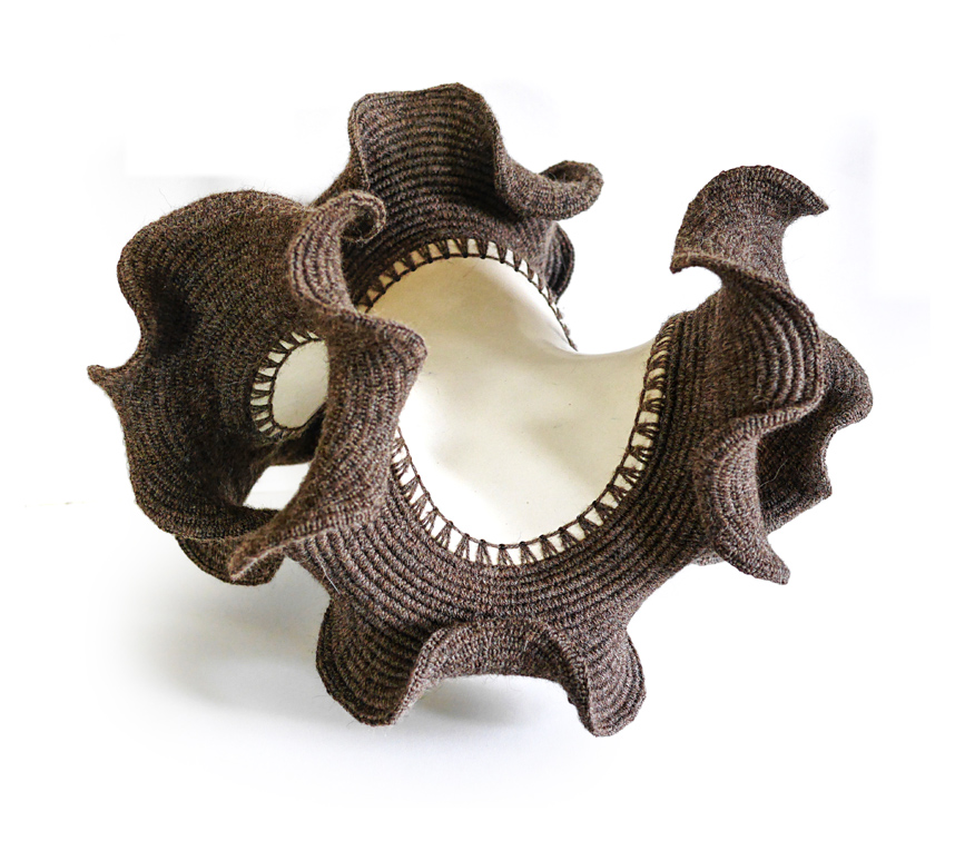 Negative-curvature abstract ceramic sculpture with crocheted upper.