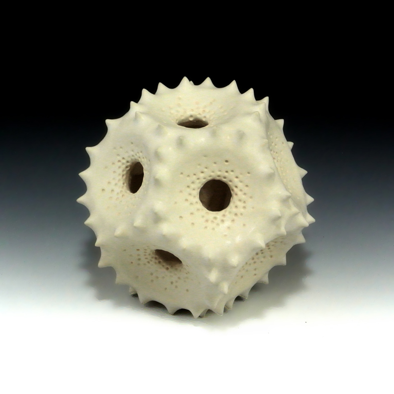 Abstract ceramic sculpture of a polyhedral form inspired by pollen grains.