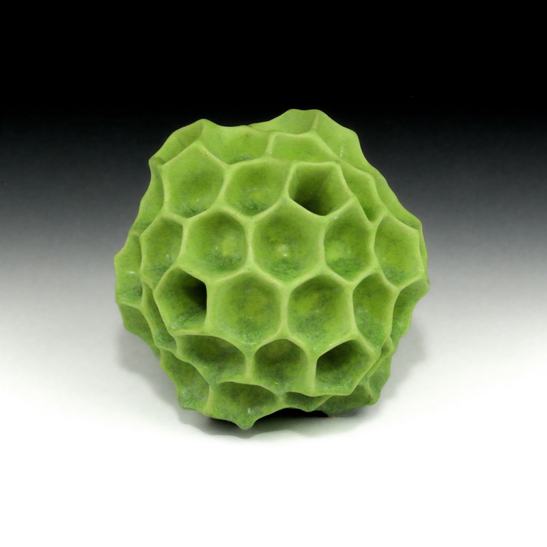 Abstract ceramic sculpture of a polyhedral form inspired by pollen grains.