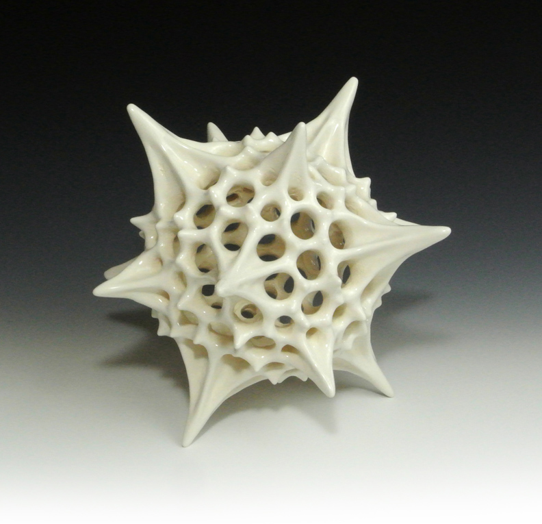 Ceramic sculpture of a biological polyhedral form, first view.